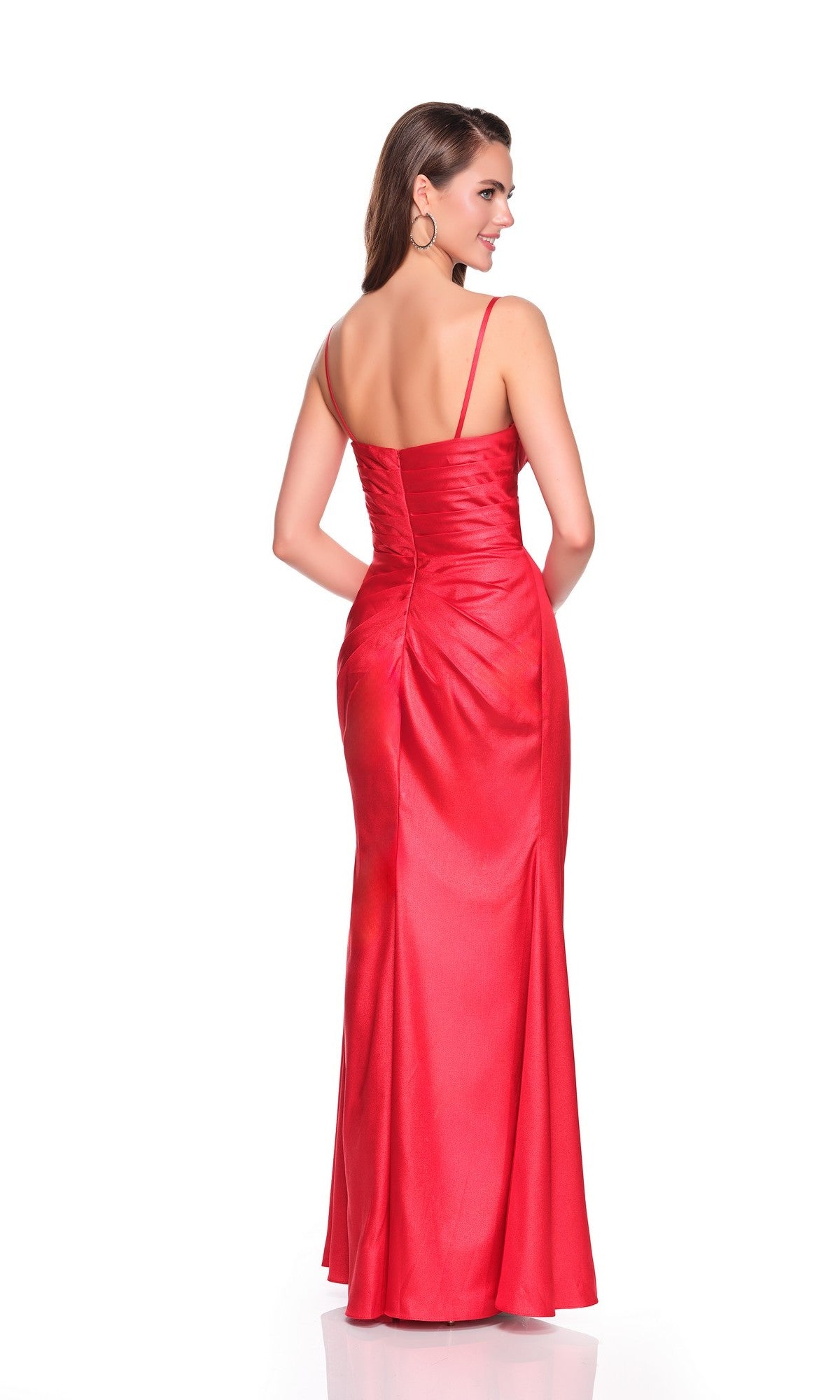 Woman wearing the Dave and Johnny 12528 long prom dress in red with thin straps and a cowl neckline, facing away and looking over her shoulder against a white background.